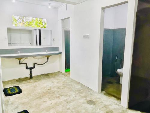 a bathroom with a sink and a toilet at Pilgrims Nature Villa in Ahangama