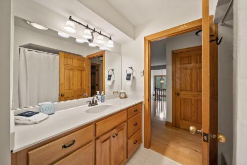 a bathroom with a sink and a large mirror at Chetola: Sierra 1 in Blowing Rock