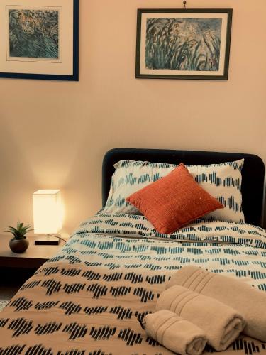 a bed with a blue and white comforter at L'Angolo di Palermo in Palermo
