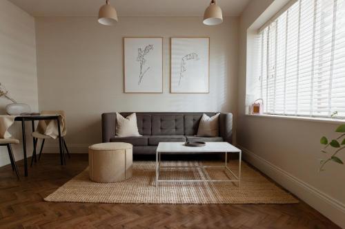 a living room with a couch and a table at HIDEOUT Hotel in Hull