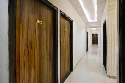 a hallway with wooden doors in a building at Via Blissful Stays in Mumbai