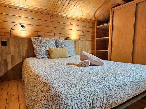a bedroom with a bed with a wooden wall at Chalet du Bief , Morillon 4-6 pers in Morillon