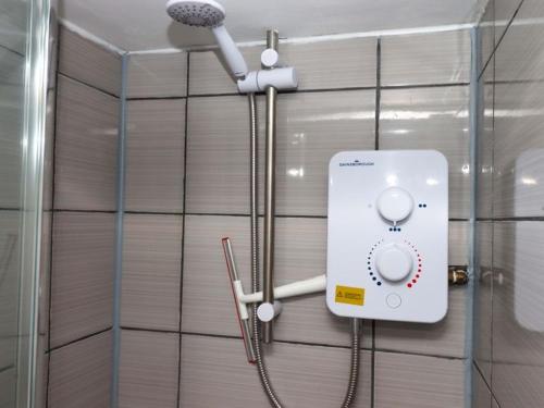 a shower in a bathroom with a shower at Kenny cottage - 1 The Court in Dawlish