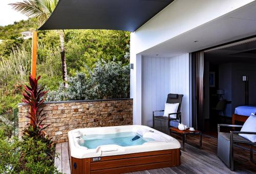 a jacuzzi tub sitting on top of a patio at Tropical heaven in Les Trois-Îlets