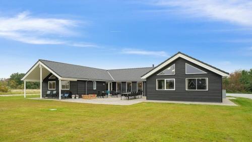 a black house with a large yard at Villavilla 474 - Grenå Strand, Østjylland in Grenå
