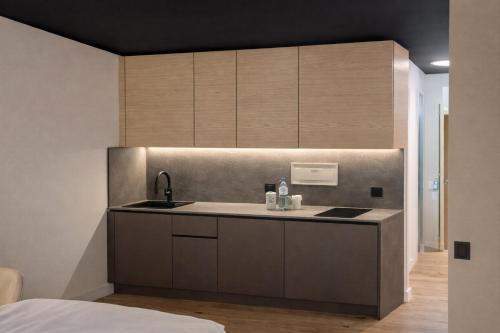 a kitchen with a sink and a counter at BEELiving Augsburg in Augsburg