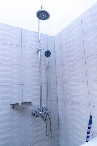 a shower with a shower head in a bathroom at Sastar Homes in Iringa