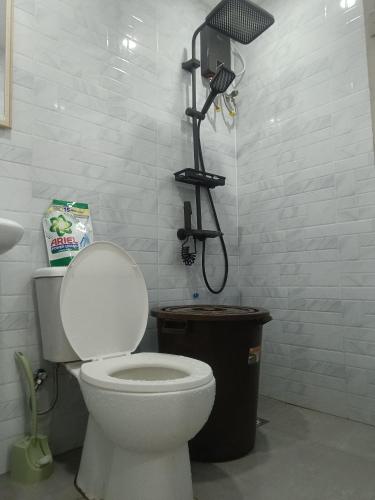 a bathroom with a toilet and a shower at Charming 2-Bedroom Balanga Getaway with Ample Space in Balanga
