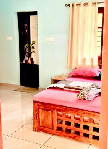 a bedroom with a bed with a red mattress at Sunshine Holidays in Varkala