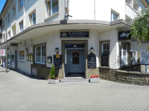 a building on a street with a sign over the door at Hotel In der Meile in Dortmund