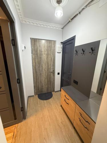 a dressing room with a wooden cabinet and a door at Terrace house Jermuk in Jermuk