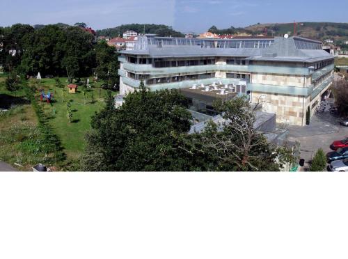 a large building with a park in front of it at Hotel Estrella Norte in Isla