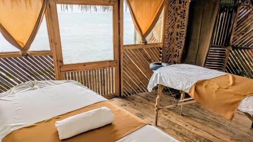 a room with a bed and a window in it at Lala Land Lodge in Kizimkazi