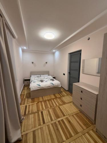 a bedroom with a bed and a dresser and a television at Terrace house Jermuk in Jermuk