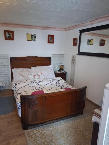 a bedroom with a large wooden bed in a room at Casa Denis rustic in Turda