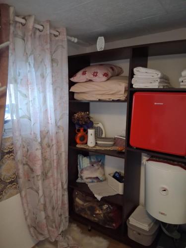 a room with a closet with a bed and a curtain at Casa Denis rustic in Turda