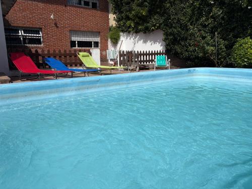 a large swimming pool with chairs in a yard at Santa Cruz 5761 in Mar del Plata
