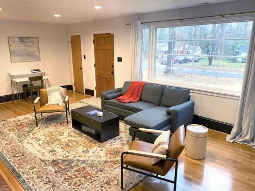a living room with a couch and chairs at Renovated Modern Home Minutes to Downtown Richmond in Richmond
