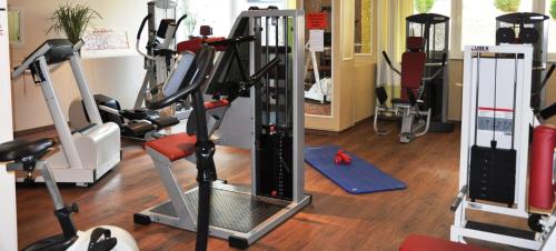a gym with treadmills and exercise equipment on the floor at Ortner's Resort in Bad Füssing