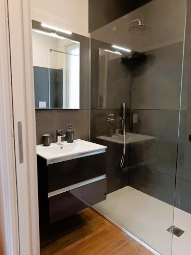 a bathroom with a sink and a shower at Orelli House - Bilocal Garden in Lissone