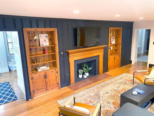 a living room with a fireplace and a tv at Renovated Modern Home Minutes to Downtown Richmond in Richmond