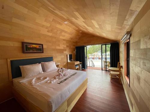 a bedroom with a large bed with towels on it at Royal C Resort in Koh Rong Island