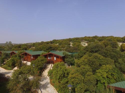 an aerial view of a house in the woods at Mountain Breeze Lodge & Resort in Al Salt