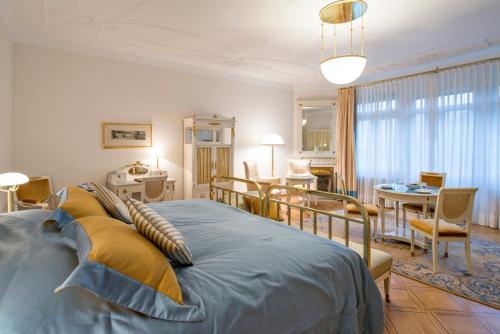 een slaapkamer met een bed en een eetkamer bij Hotel Waldhaus Sils in Sils Maria