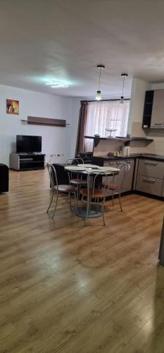 a room with a table and chairs in a kitchen at DD's place in Sibiu