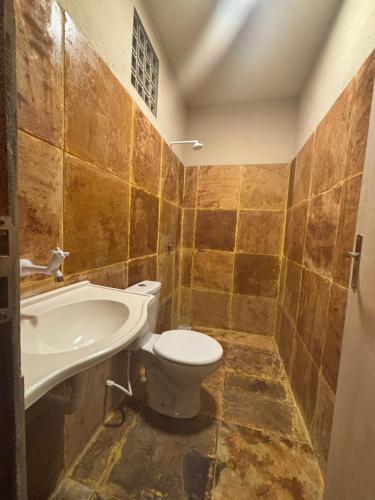 a bathroom with a toilet and a sink at Casa Girasol in Trairi