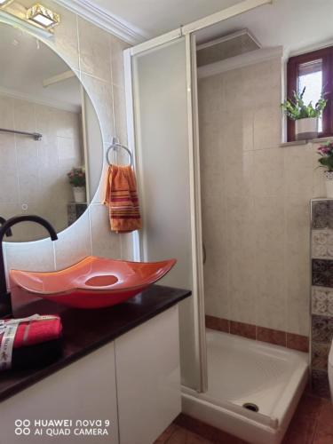 a bathroom with a red sink and a shower at AVRA House in Karfas