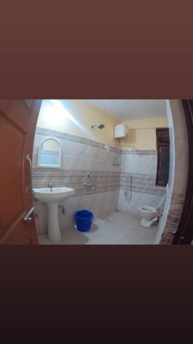 a bathroom with a sink and a toilet at Hotel Pelican in Kalimpong