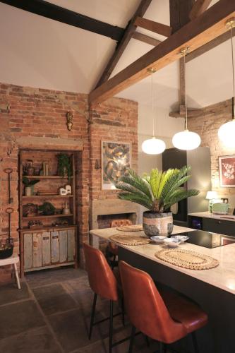 a kitchen with a table and chairs in a room at Lock Keepers Cottage at Salterhebble in Exley