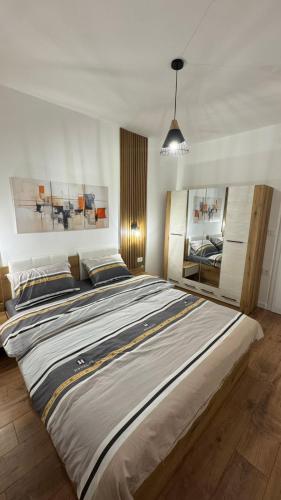 a large bed in a white room with a large bed sidx sidx sidx at Emi Center Apartments in Gevgelija