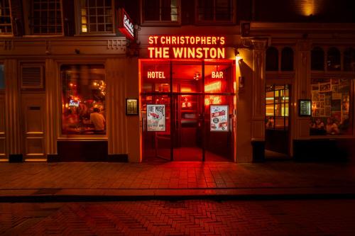 a building with a sign that reads st christoppers the winner at St Christopher's Inn Amsterdam - The Winston in Amsterdam