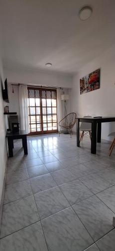 a living room with a piano and a table at Exelente Departamento in La Plata