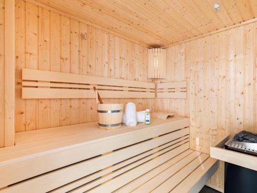 a wooden sauna with two towels and a bucket at Prora - Ferienwohnung mit Sauna - Meer geht immer in Binz