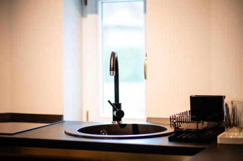 a kitchen counter with a sink and a window at Ghica Boutique Suites in Vaslui