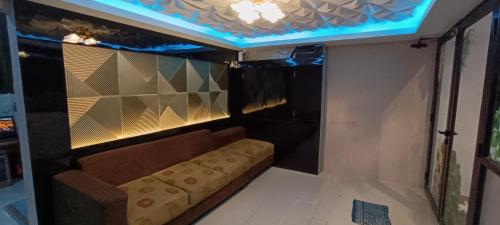 a couch sitting in a room with a ceiling at New Arcadia Residence in Jakarta