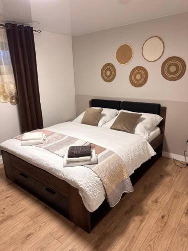 a bedroom with a large bed with white sheets and pillows at JB apartments in Liptovský Mikuláš