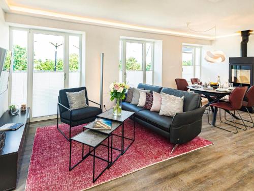 a living room with a couch and a table at Prora - Dachgeschoss Wohnung mit Sauna - Sky Lodge in Binz