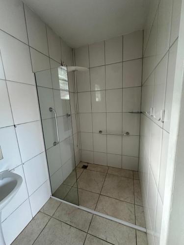 a bathroom with a shower and a sink at Pousada Guanumbi in Morretes