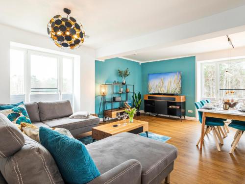 a living room with a couch and a table at Prora - Apartment mit Sauna - Baltic Sunset in Binz