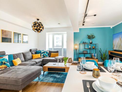 a living room with a couch and a table at Prora - Apartment mit Sauna - Baltic Sunset in Binz