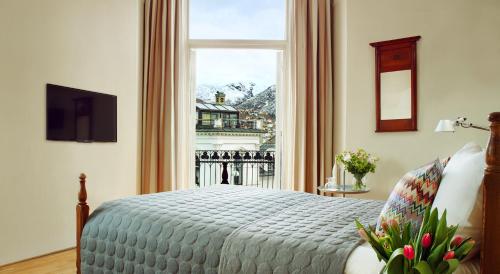 a bedroom with a bed and a large window at Hotel Park Bergen in Bergen