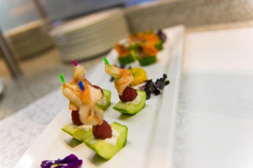 a white plate topped with appetizers on a table at Alpinresort ValSaa - Sport & Spa in Saalbach Hinterglemm
