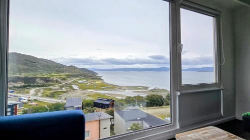 a large window with a view of the ocean at Turek Residences in Ushuaia