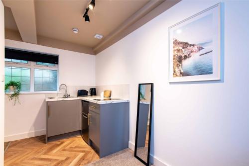 a kitchen with a sink and a counter at The Coach House, Gatwick in Horley