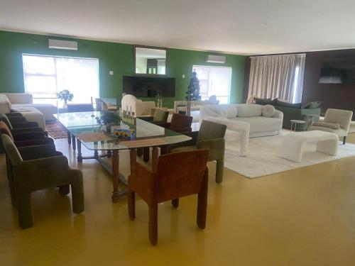 a living room with a couch and a table and chairs at Magents Farm Guesthouse in Paarl