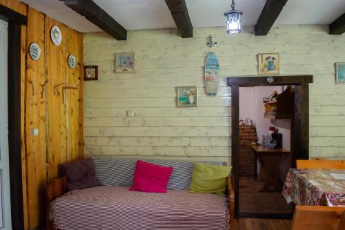 a room with a couch with colorful pillows on it at Pensiunea Padina in Bran